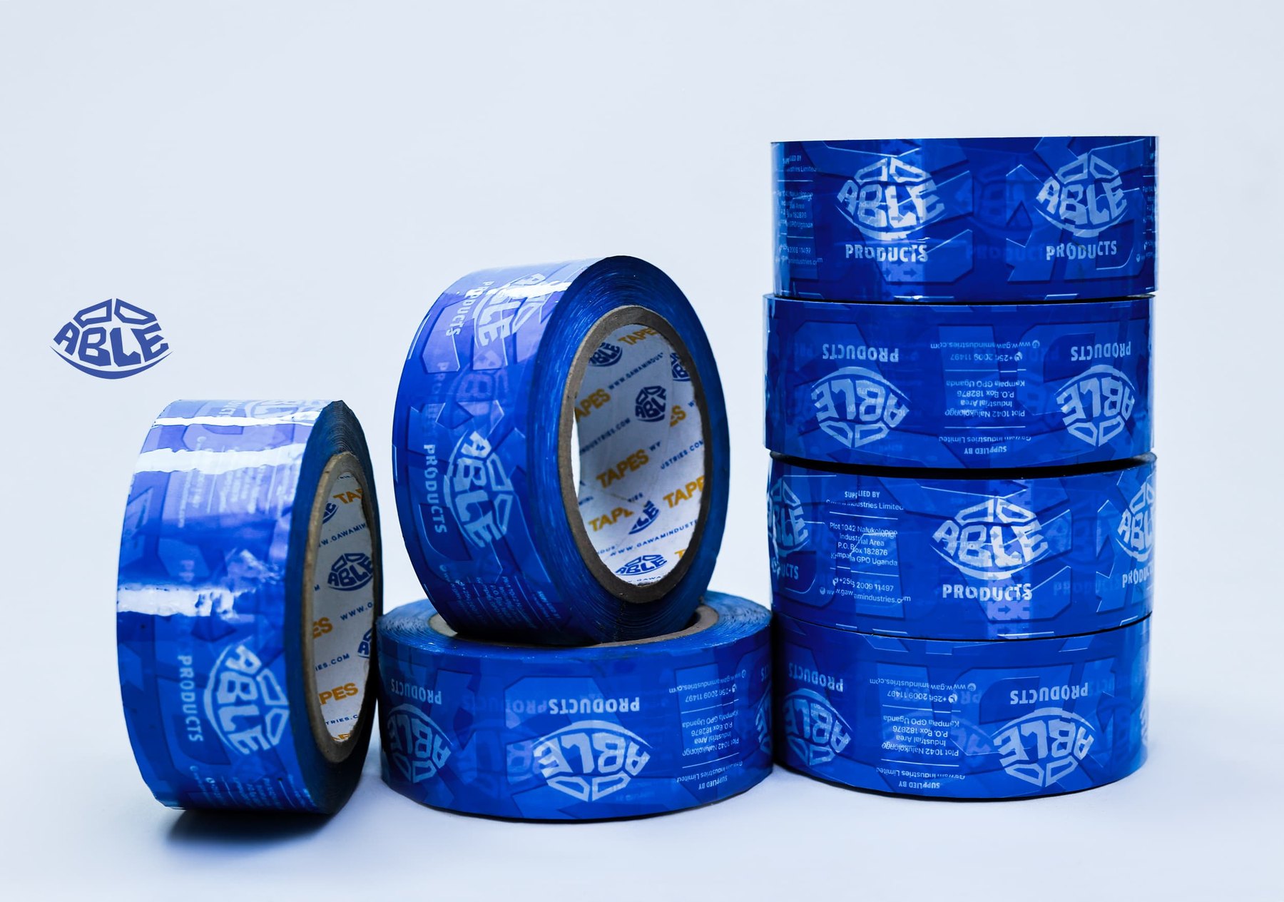 Blue ABLE adhesive tape rolls arranged in retail packs